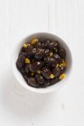 Salentina olives with orange in bowl — Stock Photo
