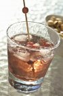 Whiskey cocktail with cherries — Stock Photo