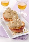 Peaches with ice cream and chopped nuts — Stock Photo