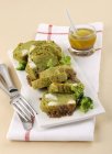 Broccoli terrine on white plate with fork over towel — Stock Photo