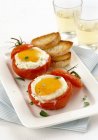 Tomatoes with fried eggs — Stock Photo