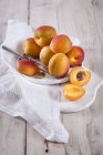 Apricots whole and halved — Stock Photo