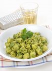 Gnocchetti con prezzemolo - mini gnocchi with parsley sauce  on white plate — Stock Photo