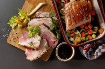Primer plano de cerdo asado crujiente con salsa balsámica y verduras de colores (visto desde arriba ) - foto de stock