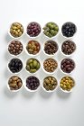 Colorful prepared olives in white bowls — Stock Photo