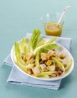 Salada de frango com anchovas no prato — Fotografia de Stock