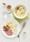Potato salads with boiled eggs and gherkins — Stock Photo