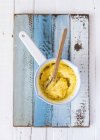 Top view of creamy Polenta with spoon in a saucepan — Stock Photo