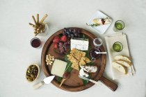 Wooden  cheesebaord with fruit — Stock Photo