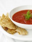 Tomato soup in bowl with tortilla chips — Stock Photo