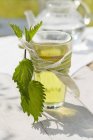 Nettle tea in glass tied with rope — Stock Photo