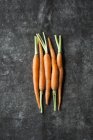 Five baby carrots — Stock Photo