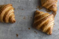 Butter croissants on grey — Stock Photo
