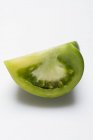 Wedge of green tomato — Stock Photo