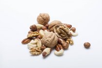 Mixed whole and cracked nuts — Stock Photo