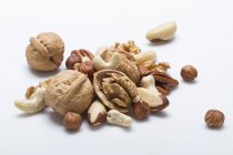 Whole and cracked mixed nuts — Stock Photo