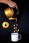 Conchiglie pasta being poured from teapot — Stock Photo