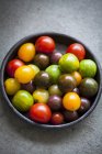 Assorted tomatoes in dish — Stock Photo