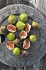 Fresh figs with slices on plate — Stock Photo