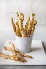 Closeup view of savoury puff pastry straws in a mini bucket — Stock Photo