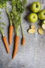 Fresh carrots on grey — Stock Photo