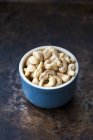 Cashew nuts in blue bowl — Stock Photo
