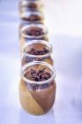 Closeup view of chocolate and caramel cream in glass jars — Stock Photo