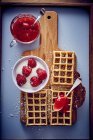 Waffles with raspberries and strawberry coulis — Stock Photo