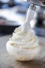 Small meringues with whipped cream — Stock Photo