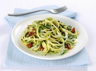Spaghetti pasta with courgette and olives — Stock Photo