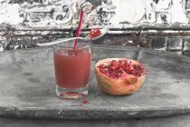 Pomegranate juice in glass — Stock Photo