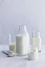 Still life with different dairy produce in glass vessels — Stock Photo
