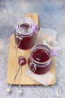 Red fruit jam in glass jars — Stock Photo