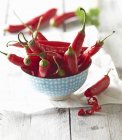 Red chili peppers in a porcelain bowl — Stock Photo