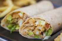 Closeup view of two wraps with fried calamari and lettuce — Stock Photo