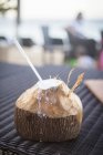 Coco fresco con la parte superior cortada - foto de stock
