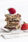 Closeup view of stack of strawberry cumble slices with strawberries and spoon — Stock Photo