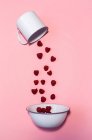 Raspberries falling out of enamel cup — Stock Photo