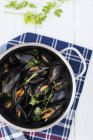 Closeup top view of mussels in herb broth — Stock Photo