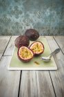 Passion fruits on chopping board — Stock Photo