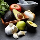 Ingredients for guacamole: avocado, onion, tomato, garlic and coriander — Stock Photo