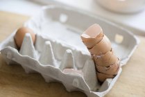 Stack of eggshells in egg carton — Stock Photo