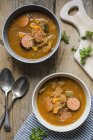 Flavoursome sauerkraut cabbage soup with smoked sausage — Stock Photo
