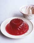 Portion of red jelly shaped like cake — Stock Photo