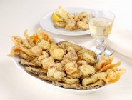 Vegetable fritto misto on white plates  over wooden surface — Stock Photo