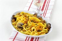 Fettucine with sausage and clams — Stock Photo