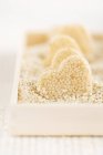 Closeup view of homemade heart-shaped sesame seed sweets — Stock Photo