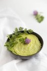 Avocado dip in a bowl on white surface — Stock Photo