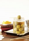 Jar of marinated green olives — Stock Photo