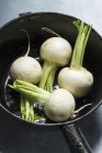 Fresh white radishes in saucepan — Stock Photo